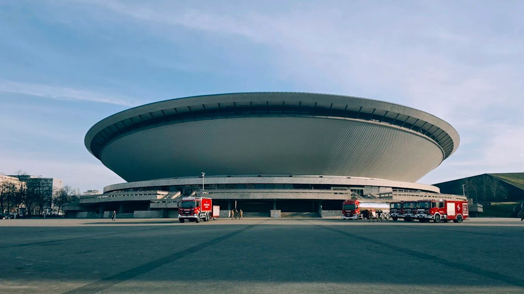Outside broadcast van with satellite dish parked at a sports venue